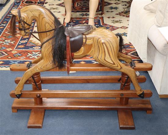 A carved wooden rocking horse H.88cm